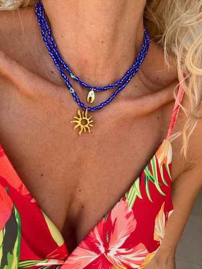 Blue beaded necklaces with gold sea charm: Crab claw necklace