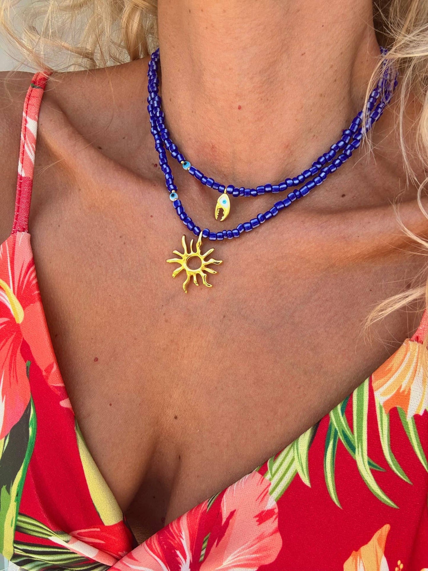 Blue beaded necklaces with gold sea charm: Crab claw necklace